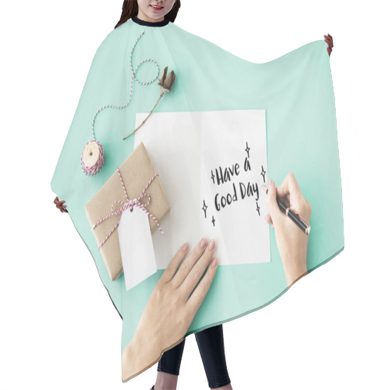 Personality  person writing on greeting card hair cutting cape