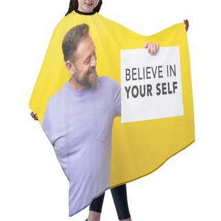 Personality  Middle Age Caucasian Man Isolated On Yellow Background Holding A Placard With Text Believe In Your Self Hair Cutting Cape