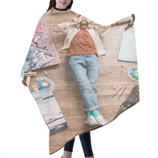 Personality  Overhead View Of Tired Artist Lying On Wooden Floor In Painting Studio And Holding Hands On Face Hair Cutting Cape