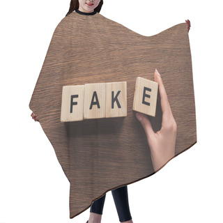 Personality  Cropped Image Of Journalist Taking Wooden Cubes With Word Fake At Wooden Table Hair Cutting Cape