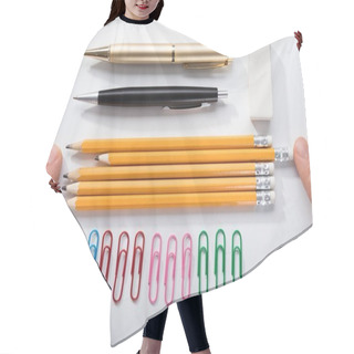 Personality  Person's Finger Arranging The Pencils With Row Of Pins Rubber And Pen On White Background Hair Cutting Cape