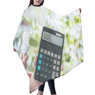 Personality  Cropped View Of Fluorescent Lamp And Calculator In Male Hands, Energy Efficiency Concept Hair Cutting Cape