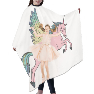 Personality  Top View Of Cheerful Kid Looking At Camera And Gesturing Near Unicorn On White  Hair Cutting Cape