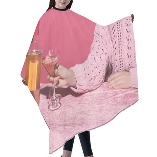 Personality  Cropped View Of Woman Holding Glass Of Rose Wine Near Bottle On Velour Cloth Isolated On Pink, Girlish Concept  Hair Cutting Cape