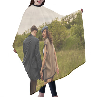 Personality  Fashionable Brunette Woman In Vest And Newsboy Cap Looking At Camera And Holding Hand Of Bearded Boyfriend And Walking With Landscape At Background, Stylish Couple In Rural Setting Hair Cutting Cape
