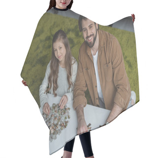 Personality  High Angle View Of Father And Daughter Sitting At Table With Puzzle Pieces And Looking At Camera Hair Cutting Cape