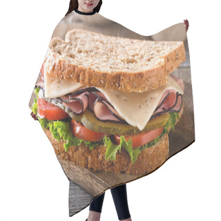 Personality  A Delicious Ham And Cheese Sandwich With Lettuce, Tomato And Dill Pickle On A Rustic Wood Table. Hair Cutting Cape