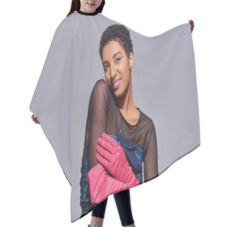 Personality  Smiling And Trendy African American Model In Cocktail Dress And Pink Gloves Touching Arm And Looking At Camera While Posing Isolated On Grey, Modern Generation Z Fashion Concept Hair Cutting Cape