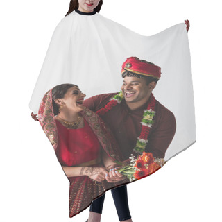 Personality  Happy Indian Bridegroom In Turban Hugging Cheerful Bride In Sari With Flowers Isolated On Grey Hair Cutting Cape