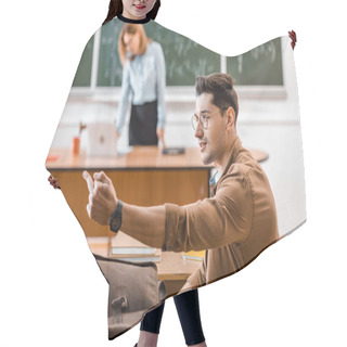 Personality  Student Showing Middle Finger In Classroom With Female Teacher On Background  Hair Cutting Cape