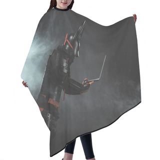 Personality  Side View Of Of Samurai Using Laptop On Dark Background With Smoke Hair Cutting Cape