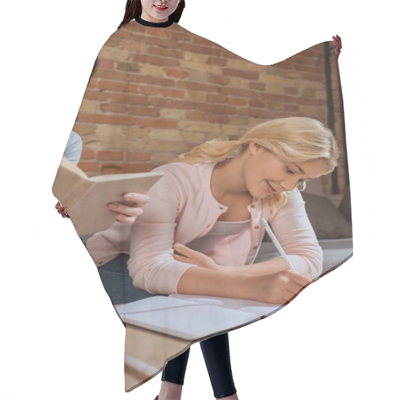 Personality  Selective Focus Of Woman Holding Book While Kid Writing On Notebook On Coffee Table At Home  Hair Cutting Cape
