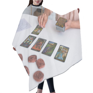 Personality  KYIV, UKRAINE - JUNE 29, 2022: Cropped View Of Fortune Teller Laying Out Tarot Cards Near Star Chart And Blurred Clay Runes Hair Cutting Cape