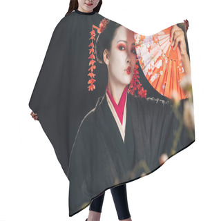 Personality  Selective Focus Of Geisha In Black Kimono With Red Flowers In Hair Holding Hand Fan And Sakura Branches Isolated On Black Hair Cutting Cape