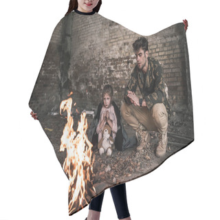 Personality  Selective Focus Of Man And Child Sitting Near Bonfire, Post Apocalyptic Concept Hair Cutting Cape