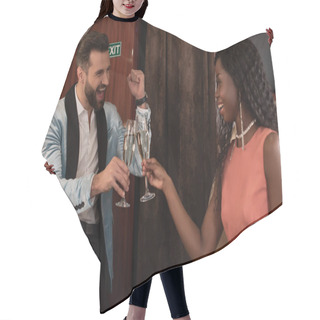 Personality  Excited Man Showing Yeah Gesture While Clinking Glasses Of Champagne With Elegant African American Woman In Plane Hair Cutting Cape