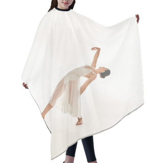 Personality  Graceful Young Woman In Flowing White Attire Performs A Perfect Handstand In A Studio Setting Against A Clean White Backdrop. Hair Cutting Cape