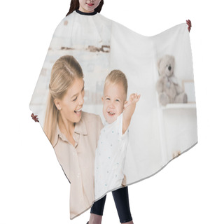 Personality  Cheerful Mother Holding Smiling Son In Nursery Room Hair Cutting Cape