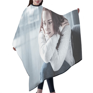 Personality  Stressful Unhappy Woman Hugging Herself And Looking Down. Hair Cutting Cape