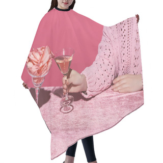 Personality  Cropped View Of Woman Holding Glass Of Rose Wine Near Glass With Rose Petals On Velour Cloth Isolated On Pink, Girlish Concept  Hair Cutting Cape