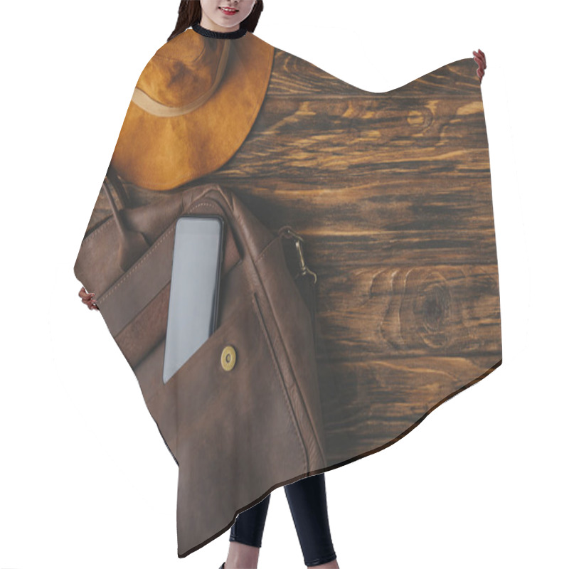 Personality  Top View Of Brown Leather Bag With Smartphone And Hat On Wooden Table, Travel Concept Hair Cutting Cape