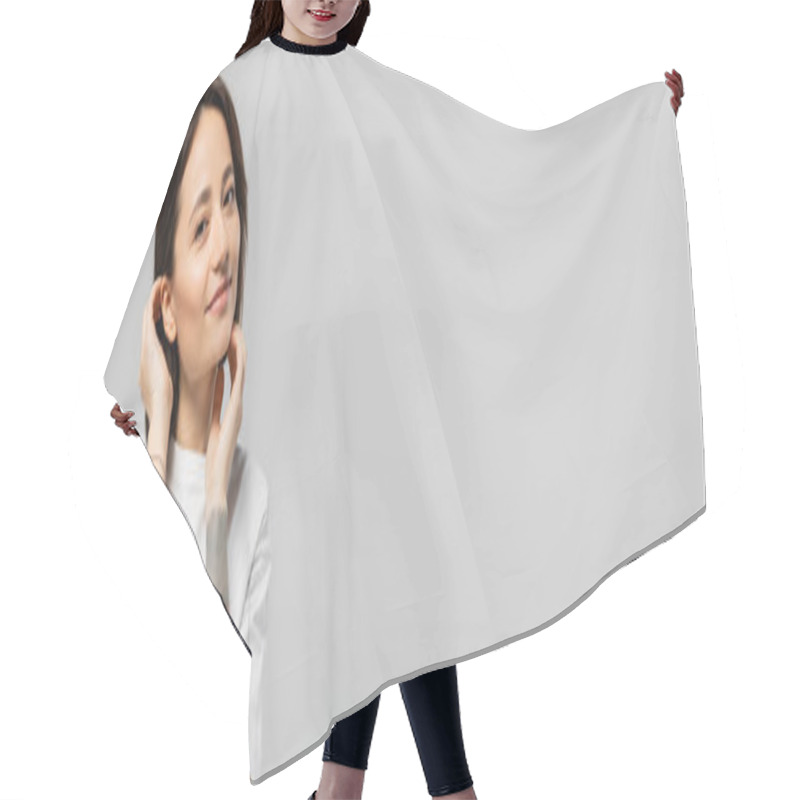 Personality  Enchanting And Tattooed Woman Touching Her Short Hair And Standing In White T-shirt, Smiling While Looking At Camera Isolated On Grey Background With Copy Space, Banner Hair Cutting Cape