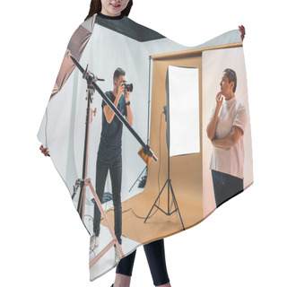 Personality  Stock Photo Of Professional Photographer During Photo Shoot In Studio. Hair Cutting Cape