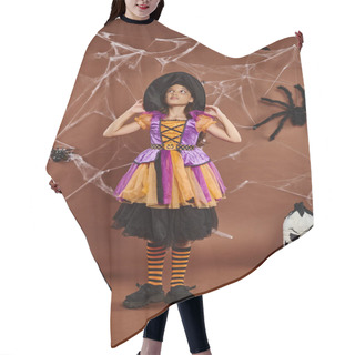 Personality  Girl In Witch Hat And Halloween Costume Standing Near Spooky Decor And Cobwebs On Brown Backdrop Hair Cutting Cape