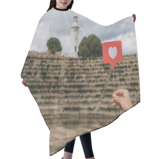Personality  Cropped View Of Woman Holding Like On Stick Near Amphitheater And Lighthouse  Hair Cutting Cape