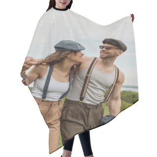 Personality  Smiling Bearded Man In Vintage Outfit And Newsboy Cap Hugging Brunette Girlfriend With Suspenders And Walking With Scenic Landscape At Background, Stylish Couple Enjoying Country Life Hair Cutting Cape