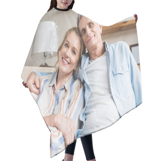 Personality  Happy Senior Couple Embracing And Smiling At Camera In New House Hair Cutting Cape