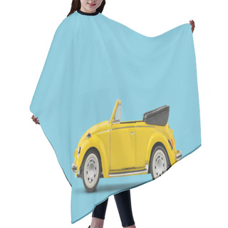 Personality  Model Of Yellow Retro Toy Car Cabriolet On Solid Blue Background. Miniature Car Side View With Copy Space Hair Cutting Cape
