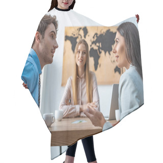 Personality  Selective Focus Of Smiling Travel Agent Looking At Disputing Couple Of Tourists Hair Cutting Cape