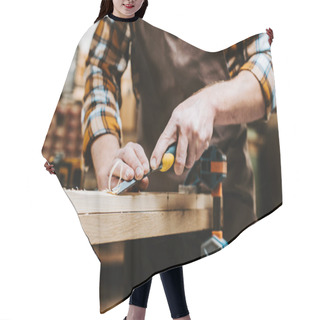 Personality  Cropped View Of Woodworker Holding Chisel While Carving Wood In Workshop  Hair Cutting Cape