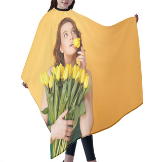 Personality  Portrait Of Pensive Woman With Tulip In Mouth And Bouquet Of Yellow Tulips Isolated On Orange Hair Cutting Cape