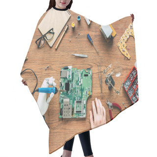 Personality  Cropped Image Of Electronic Engineer With Robotic Hand Fixing Motherboard By Soldering Iron At Table Surrounded By Tools Hair Cutting Cape