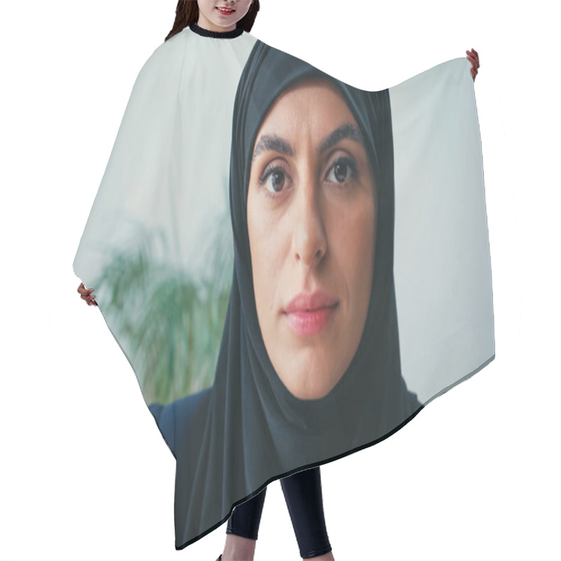 Personality  close up of young muslim businesswoman in hijab looking at camera in office  hair cutting cape