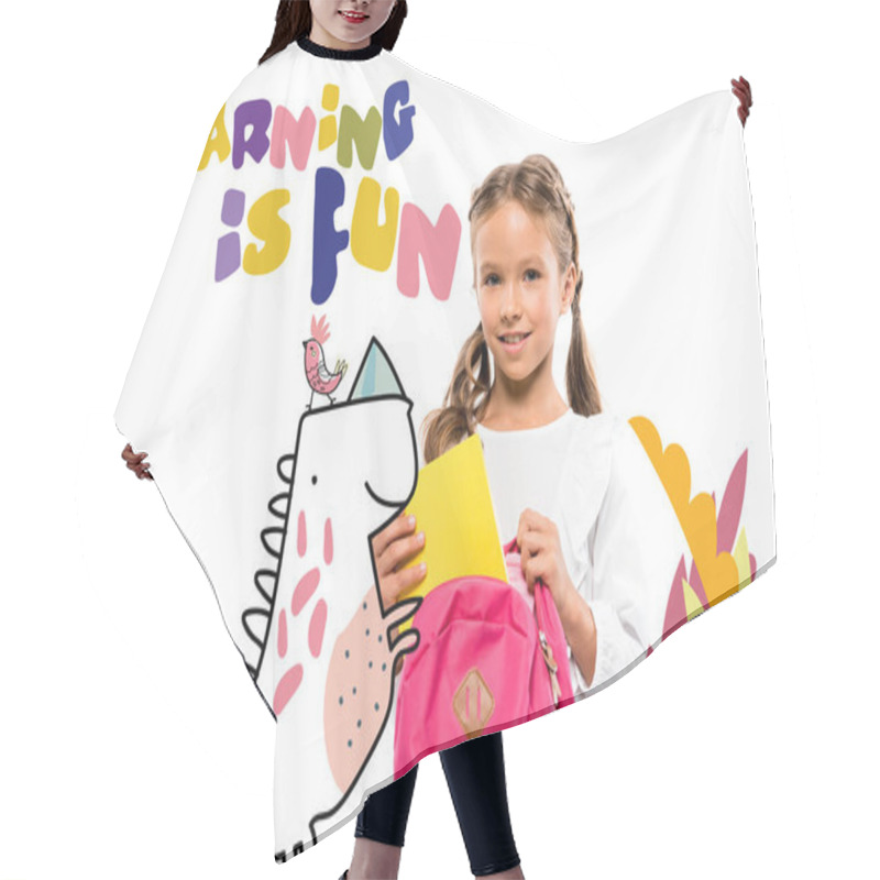 Personality  smiling child putting book in pink backpack near learning is fun lettering and fairy character on white  hair cutting cape