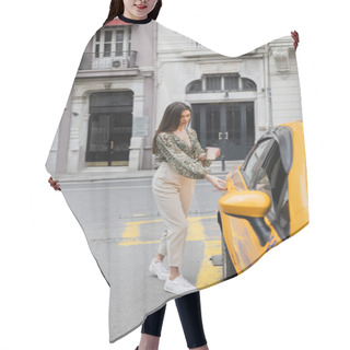 Personality  Chic Woman With Long Hair Holding Coffee In Paper Cup While Standing In Trendy Outfit With Handbag On Chain Strap And Opening Door Of Yellow Cab On Blurred Urban Street  Hair Cutting Cape