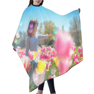 Personality  Little Beautiful Girl In Flowers Park. Tulips Garden. Hair Cutting Cape