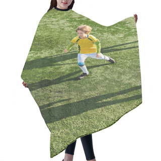 Personality  A Young Boy Energetically Kicks A Soccer Ball Across A Vibrant Green Field, Displaying Skill And Determination In His Game. Hair Cutting Cape
