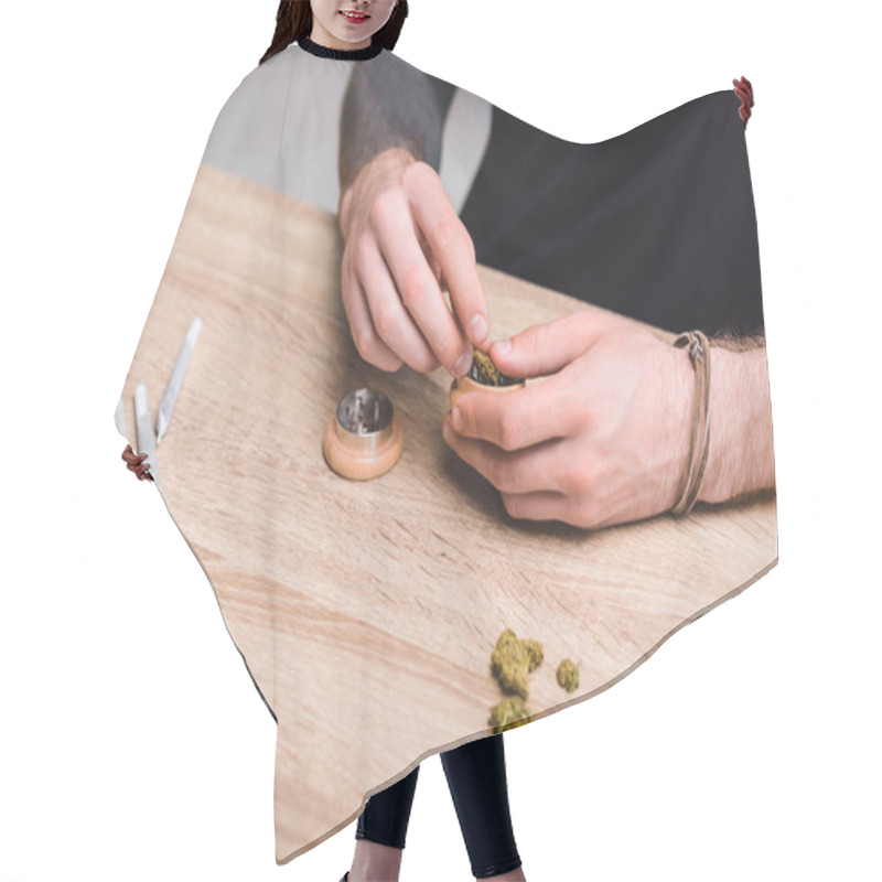 Personality  Cropped View Of Man Putting Medical Marijuana In Marijuana Crusher On Table  Hair Cutting Cape