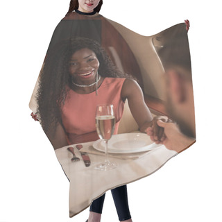 Personality  Selective Focus Of Happy African American Woman Holding Hands With Man At Served Table In Private Plane Hair Cutting Cape