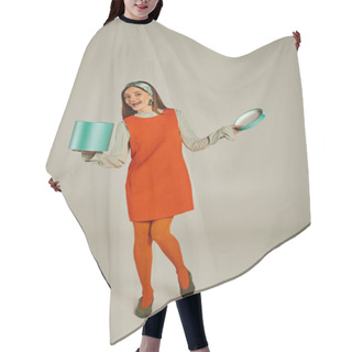 Personality  Full Length Of Woman In Orange Retro Style Dress Holding Gift Box And Looking At Camera On Grey Hair Cutting Cape