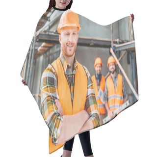Personality  Smiling Builder Standing At Construction Site With Crossed Arms While His Colleagues Standing Blurred On Background Hair Cutting Cape