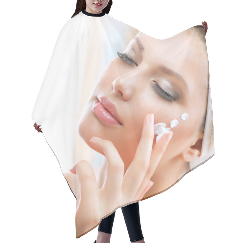 Personality  Beautiful Young Woman applying facial moisturizing cream hair cutting cape