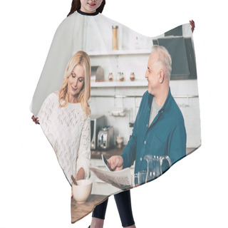 Personality  Happy Man Holding Smartphone And Newspaper Near Wife Making Breakfast In Kitchen Hair Cutting Cape