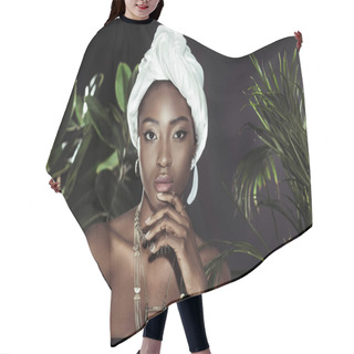 Personality  Young African American Woman In White Wire Head Wrap Behind Leaves Looking At Camera Hair Cutting Cape