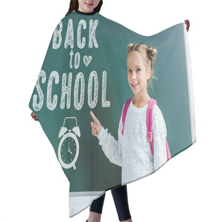 Personality  Cheerful Kid Smiling While Pointing With Finger At Back To School Lettering On Green Chalkboard  Hair Cutting Cape