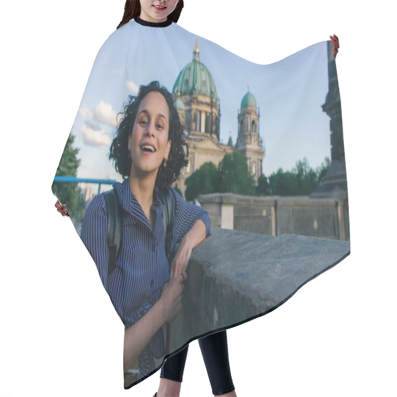Personality  BERLIN, GERMANY - JULY 14, 2020: amazed young woman near blurred berlin cathedral hair cutting cape
